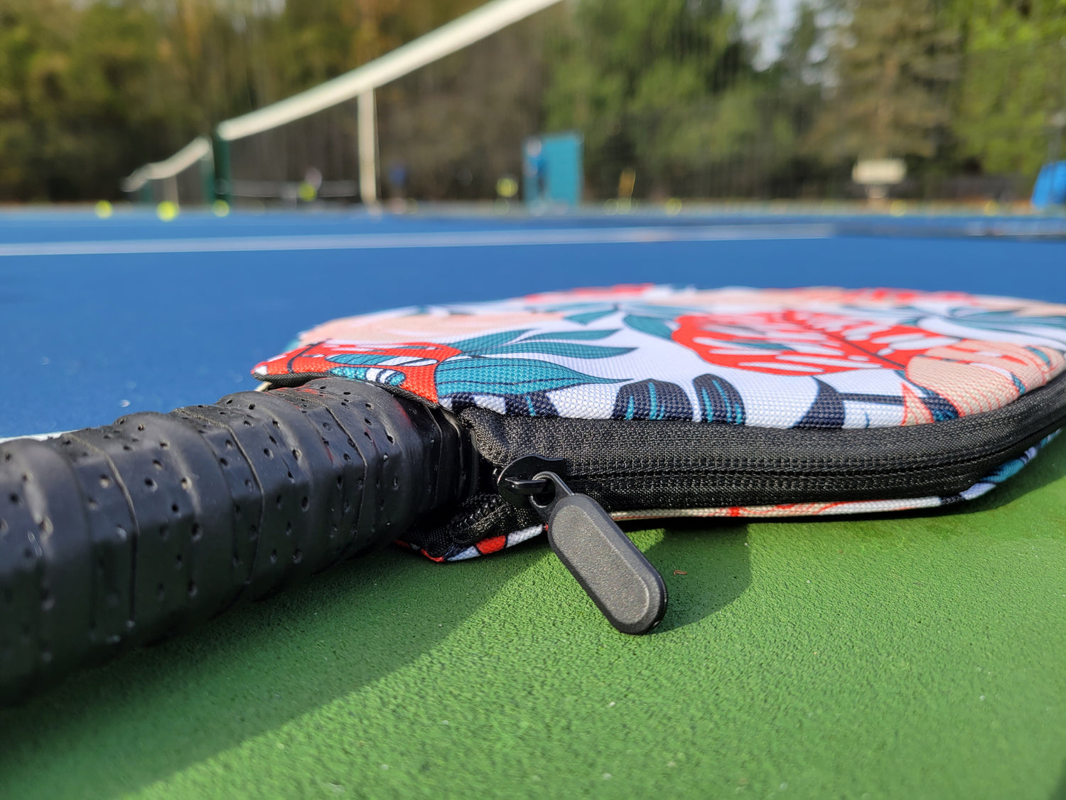 Closeup of paddle in padded cover. Ergonomic grip to wick sweat and provide comfort. Upgraded zipper and zipper full for easy on/off.