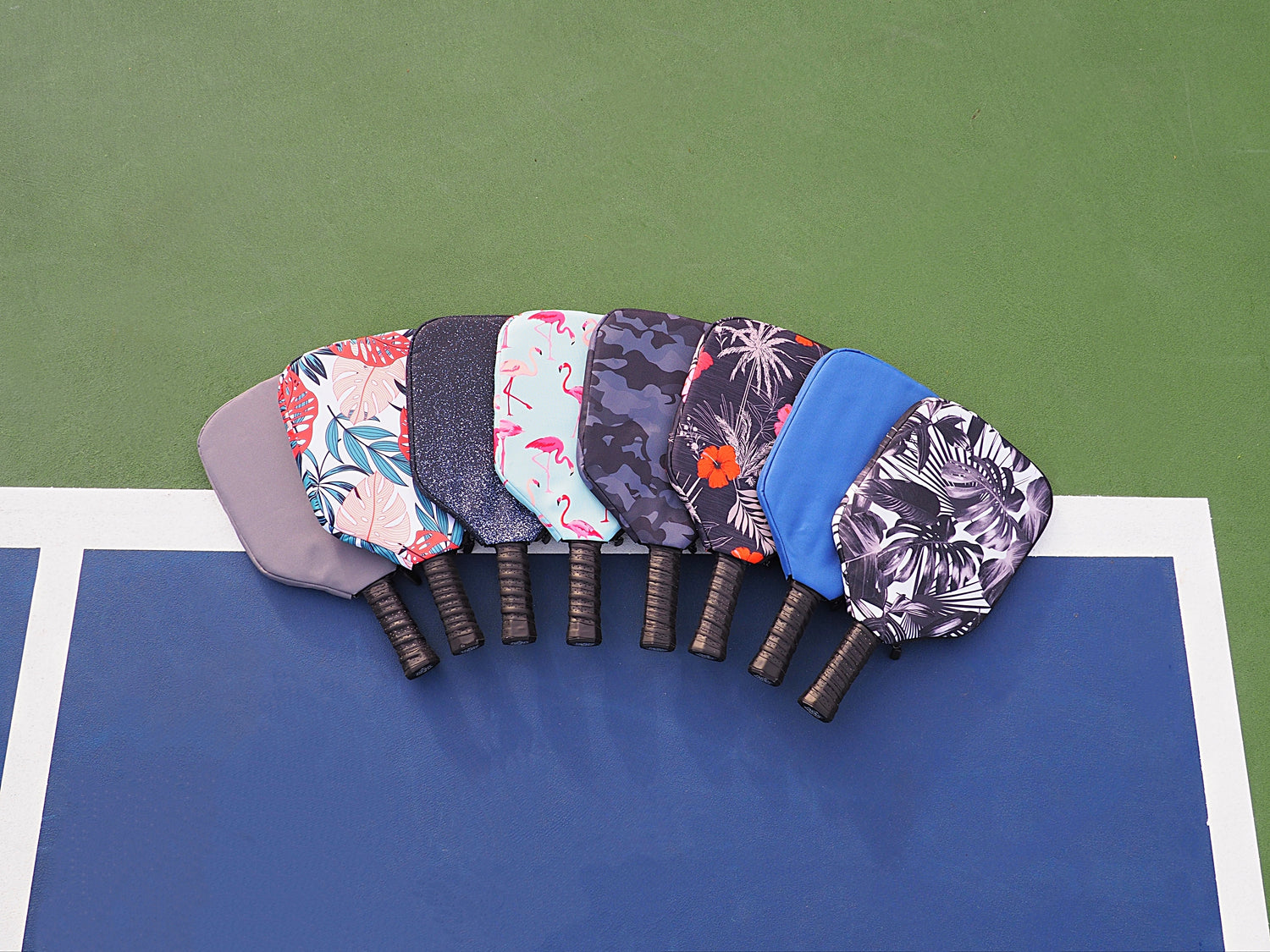 Padded pickleball paddle covers in fun prints to protect racket against scratches, dings and dents. 