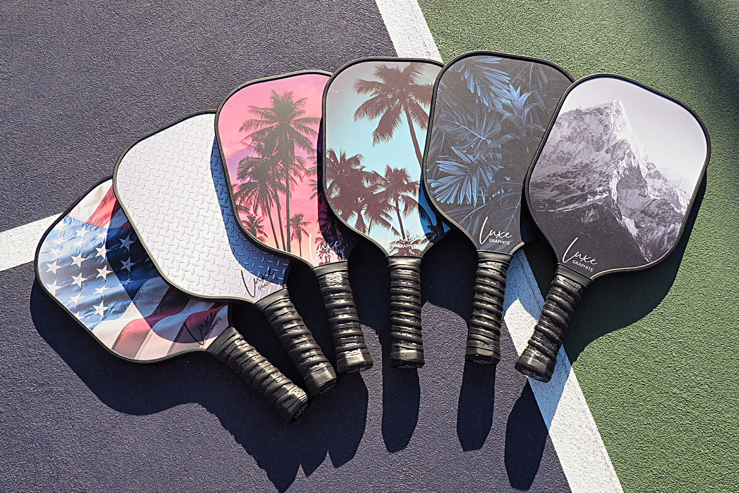 PalmsOAces carbon fiber pickleball paddles on court. Fun, colorful pickleball rackets.